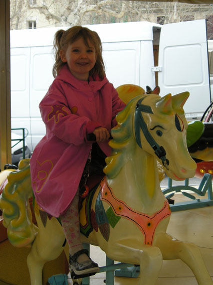 Annie on the Merry-Go-Round Horse at St. Tropez